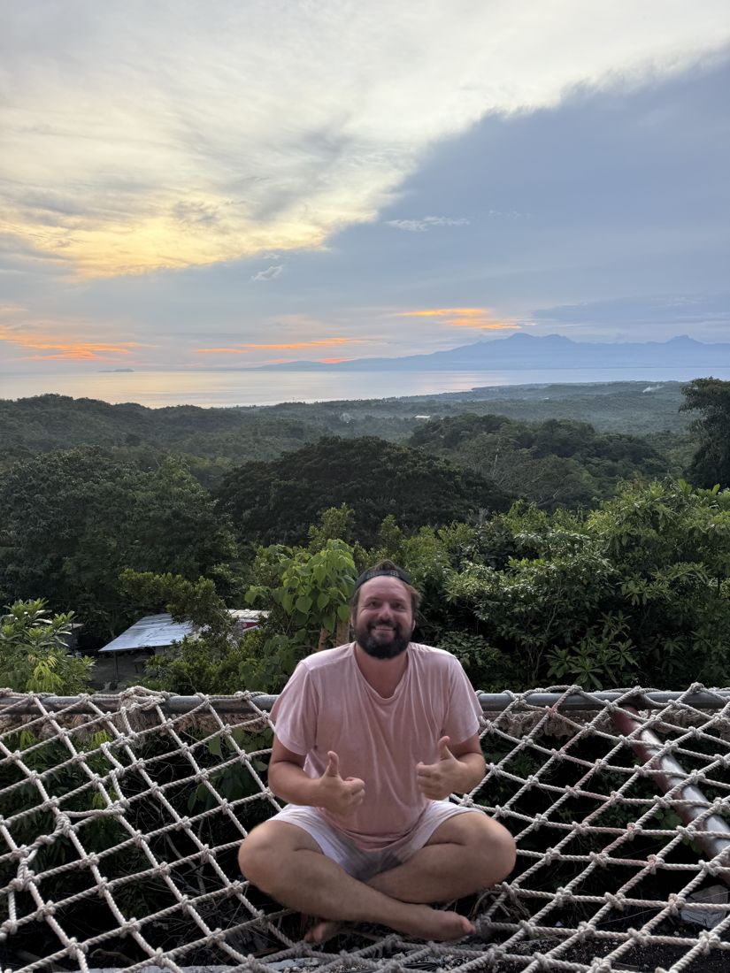 Dan sitting above a valley